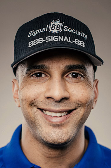 Signal 88 Security employee wearing a hat with 1-888-SIGNAL-88