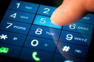 Finger pointing to the 5 key on a smartphone