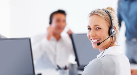 Woman with headset on and a man in the background